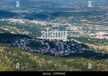 Aerial view of covilha, a city nestled amidst rolling hills and valleys, showcasing the urban sprawl and surrounding landscape under the bright summer Stock Photo