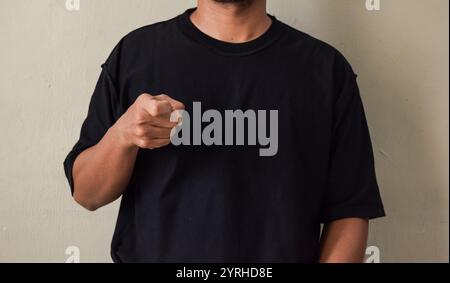 Young man interpreter of brazillian sign language, Libras, making the letter X Stock Photo