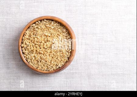 Dried elderflowers in wooden bowl on linen fabric, with empty space. Elderflower tea, Flos Sambuci, dried blossoms of European black elder. Stock Photo