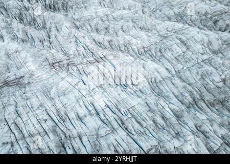 Aerial shot showing the intricate patterns and textures of a glacier The ice formations, cracks, and hues create a stunning natural abstract landscape Stock Photo