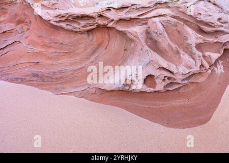 Close-up of intricate sandstone textures displaying layers and patterns in warm earthy tones, highlighting geological formations Ideal for nature or b Stock Photo