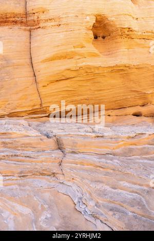Close-up of sandstone textures showcasing beautiful layered patterns in warm hues of yellow and orange The intricate layering accentuates the rock's n Stock Photo
