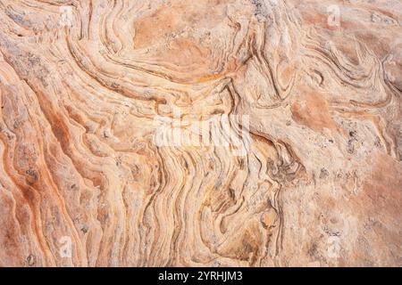 Close-up view of intricate patterns and textures in natural sandstone This detailed image captures the earthy hues and flowing lines, highlighting the Stock Photo