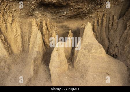 This image captures intricate sandstone formations, highlighting their detailed textures and natural patterns The soft earthy tones and shapes evoke a Stock Photo