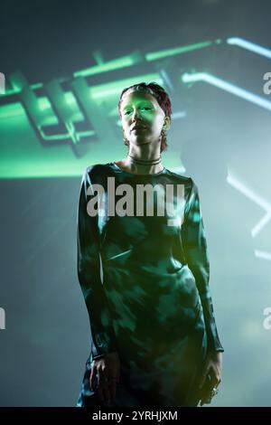 Woman styled in futuristic blue attire, framed against a gradient blue background. representing a digital avatar or character in a virtual reality env Stock Photo