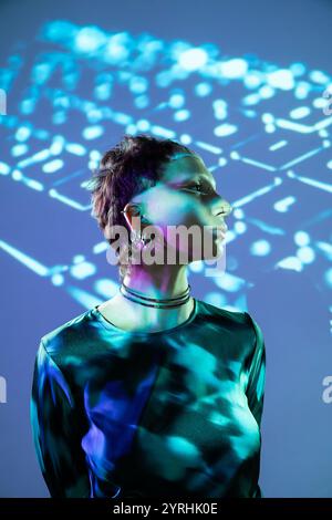 A visionary depiction of a woman engrossed in the metaverse as she is lit by dynamic, algorithmic light patterns, highlighting a futuristic aesthetic. Stock Photo