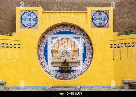 Public fountain Fonte dos Pisões was built in 1931 and has bright yellow colour. Sintra, Portugal Stock Photo