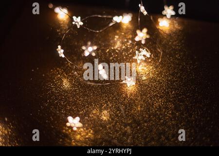Magic gold background with stars lights bokeh. Festive Christmas background. New Year wallpaper at night Stock Photo
