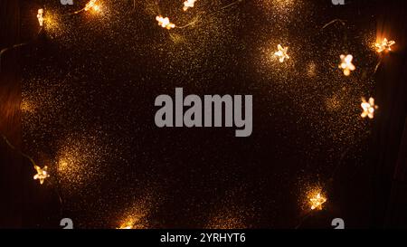Magic gold background with stars lights bokeh. Festive Christmas background. New Year golden wallpaper at night. Free copy space for design Stock Photo