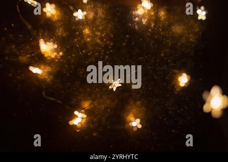 Magic gold background with stars lights bokeh. Festive Christmas background. New Year wallpaper at night Stock Photo