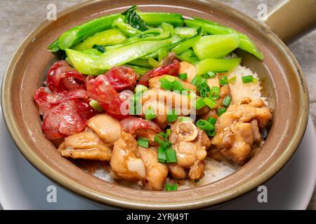 angle view chicken and Chinese sausage claypot rice with vegetable at horizontal composition Stock Photo