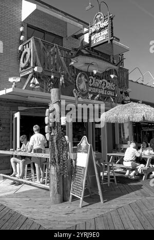 Tourists enjoying a meal at a sidewalk café along the bustling boardwalk in Myrtle Beach, South Carolina, USA. Stock Photo