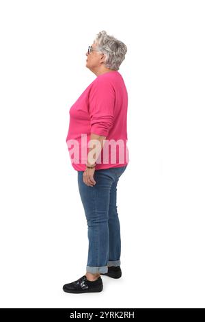 side view portrait of standing senior woman on white background Stock Photo