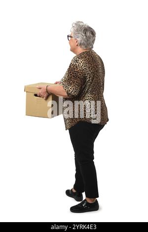 side view of senior woman holding cardboard box  on white background Stock Photo