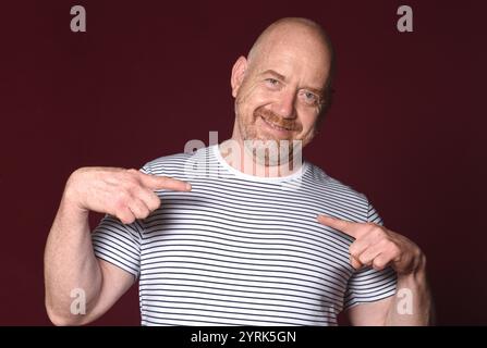 man pointing fingers at himself on red background Stock Photo
