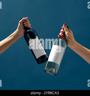Creative concept mockup with two hands holding red and white wine bottles, showcasing interaction and product versatility in branding. Negative space Stock Photo