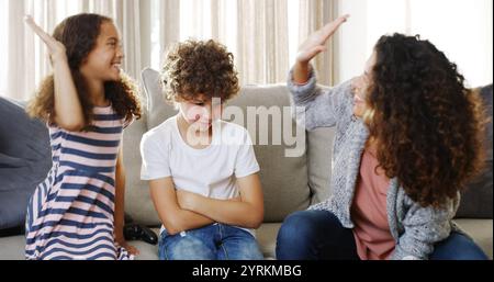 Mom, girl and high five for video games in home, loser son and celebration for playing console. Mother, children and gesture for bonding success in Stock Photo