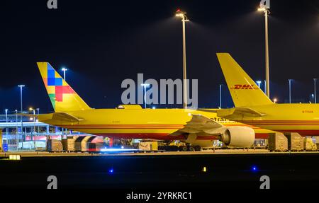 PRODUCTION - 26 November 2024, Saxony, Leipzig: DHL aircraft stand at the DHL freight center at Leipzig/Halle Airport in the late evening. With the DHL hub of Post subsidiary DHL, the airport is one of the world's most important centers for air freight. Photo: Hendrik Schmidt/dpa Stock Photo