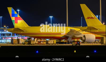 PRODUCTION - 26 November 2024, Saxony, Leipzig: DHL aircraft stand at the DHL freight center at Leipzig/Halle Airport in the late evening. With the DHL hub of Post subsidiary DHL, the airport is one of the world's most important centers for air freight. Photo: Hendrik Schmidt/dpa Stock Photo