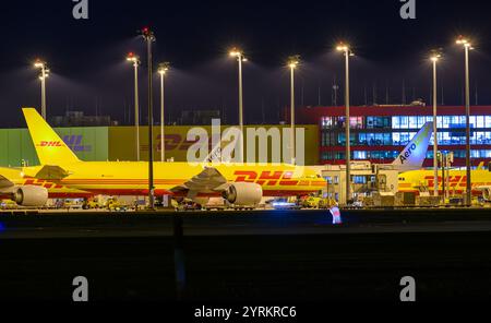 PRODUCTION - 26 November 2024, Saxony, Leipzig: DHL aircraft stand at the DHL freight center at Leipzig/Halle Airport in the late evening. With the DHL hub of the Post subsidiary DHL, the airport is one of the world's most important centers for air freight. Photo: Hendrik Schmidt/dpa Stock Photo