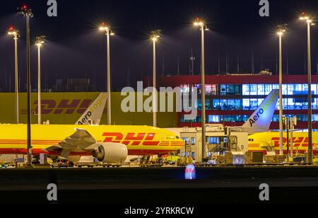 PRODUCTION - 26 November 2024, Saxony, Leipzig: DHL aircraft stand at the DHL freight center at Leipzig/Halle Airport in the late evening. With the DHL hub of the Post subsidiary DHL, the airport is one of the world's most important centers for air freight. Photo: Hendrik Schmidt/dpa Stock Photo