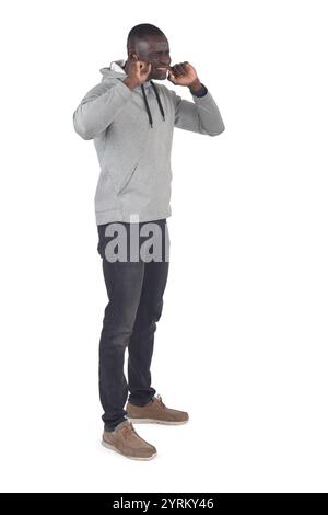 side view of  a man covering her ears from noise on white background Stock Photo