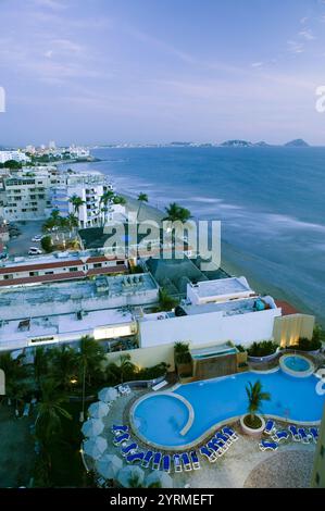 MEXICO-Sinaloa State-Mazatlan: Zona Dorado/ Golden Hotel Zone-Playa Las Gaviotas Beach view above Las Flores Hotel Pool / Evening Stock Photo