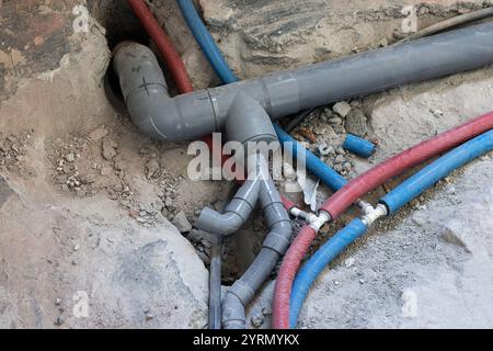 New plumbing pipes being installed during a home renovation, showing various pipe connections and fittings Stock Photo