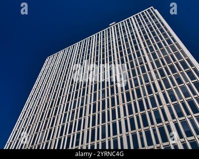 Stockholm, Sweden - Jun 25 2024: A modern high rise building against a deep blue sky. Architecture, business, corporate, financial, contemporary, mode Stock Photo