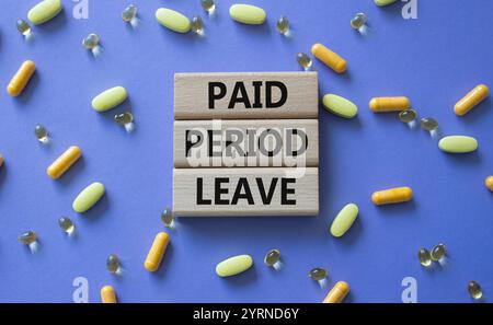 Paid Period Leave symbol. Concept words Paid Period Leave on wooden blocks. Beautiful purple background with pills. Healthcare and Paid Period Leave c Stock Photo