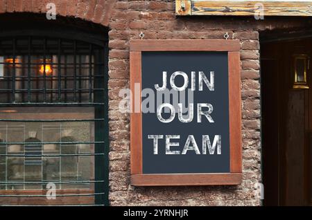 Advertising board with text Join Our Team on facade of building. Human resource Stock Photo