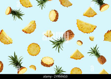 Creative pattern of Mini Chiangrai Phulae pineapple fruit slices on blue background. Mini Thai topical pineapple fruit pieces background. Pineapple fr Stock Photo