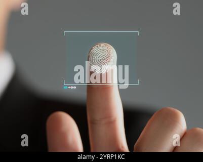 Man pressing finger to surface showing friction ridges pattern, closeup. Scanning fingerprint Stock Photo