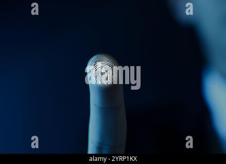 Man pressing finger to surface showing friction ridges pattern, closeup. Scanning fingerprint Stock Photo