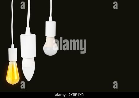 Different light bulbs hanging on black background. Space for text Stock Photo