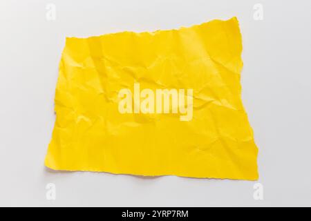 Yellow torn crumpled paper lies on a white background. Text note. Free copy space for design and text Stock Photo