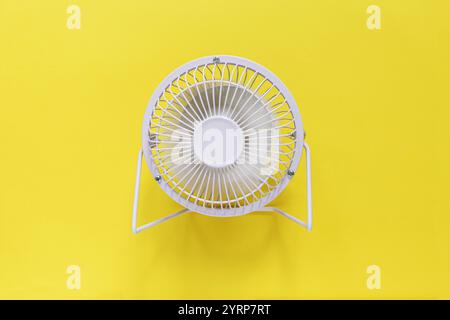 Metal mini fan on a yellow background. Heat and ventilation Stock Photo