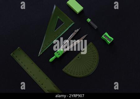 geometry set with rulers, compass, eraser, sharpener and graphite rods on black background Stock Photo