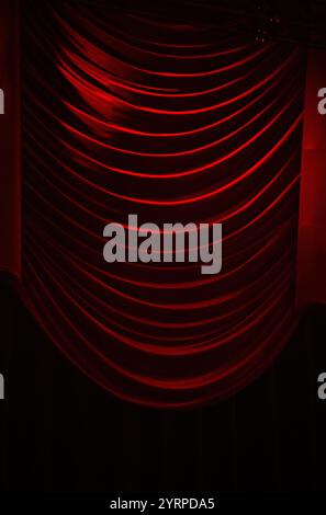 Red folded drapes in old theatre Stock Photo