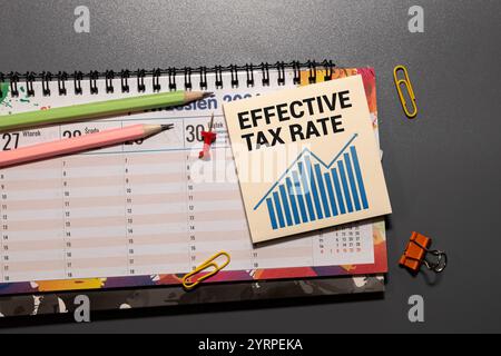 Effective Tax Rate text on a notepad on a wooden background. white pen Stock Photo