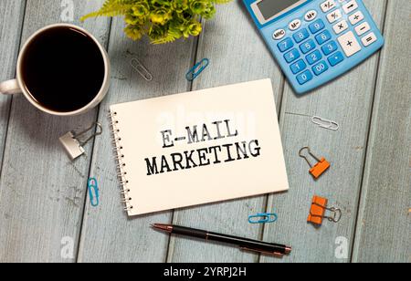 E-mail marketing and Hands. E-mail marketing Written on white paper with keyboard , calculator, glasses, felt pens on white background. Stock Photo