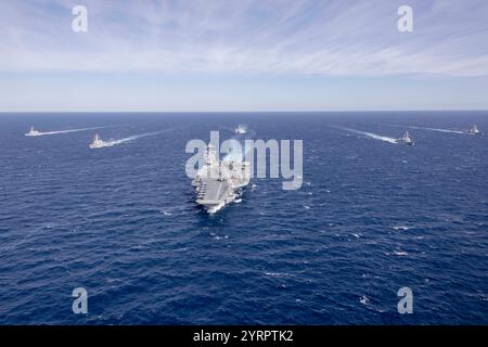 Atlantic Ocean. 12th Nov, 2024. The world's largest aircraft carrier, USS Gerald R. Ford (CVN 78), sails in formation with the Arleigh Burke-class guided missile destroyers USS Winston Churchill (DDG 81), USS Mitscher (DDG 57), USS Mahan (DDG 72), USS Bainbridge (DDG 96), and USS Forrest Sherman (DDG 98) in the Atlantic Ocean, Nov. 12, 2024. The Gerald R. Ford Carrier Strike Group is underway in the Atlantic Ocean completing Group Sail. Group Sail is the first at-sea integrated phase training event during a routine deployment training cycle. It is designed to challenge the Gerald R. Ford Stock Photo