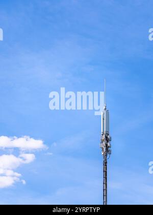mobile phone antenna tower agains blue sky background. 5G. 4G, 3G mobile technologies Stock Photo