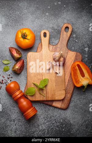 Still life with tomatoes, peppers and garlic on wooden boards Stock Photo