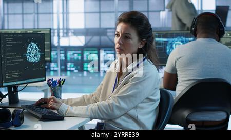Manager checking project progress of engineer programming in AI data center used for machine learning training. Team leader reading paperwork files on artificial intelligence tech, camera A Stock Photo