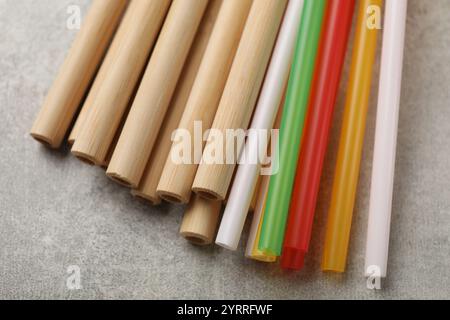 Different drinking straws on grey table, closeup Stock Photo
