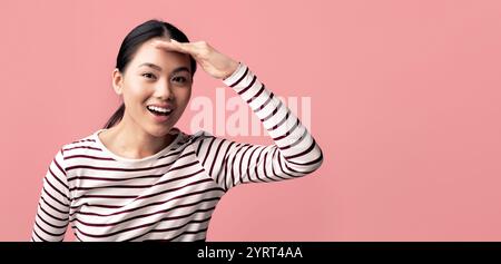 Asian Woman Keeping Hand Near Forehead And Looking At Camera With Interest Stock Photo
