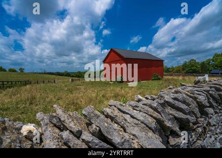 JULY 20, 2022, LEXINGTON, KY, USA - brightly colored Red Barn and rock stacks outside of Horse District of Lexington Stock Photo