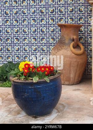 Two colorful vases and a blue patterned wall Stock Photo