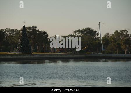 View across Vinoy Yacht Basin Marina in St. Petersburg, Florida and Park on an early morning  sunny day. Christmas tree on the left. Seawall, trees Stock Photo